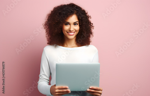Smiling pretty woman with laptop in front of pastel wall created with Generative AI technology