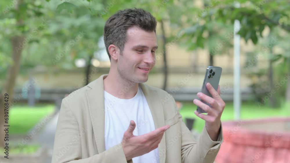 Blogging Casual Young Man Doing Online Video Chat on Smartphone Blogging Casual Young Man Doing Online Video Chat on Smartphone