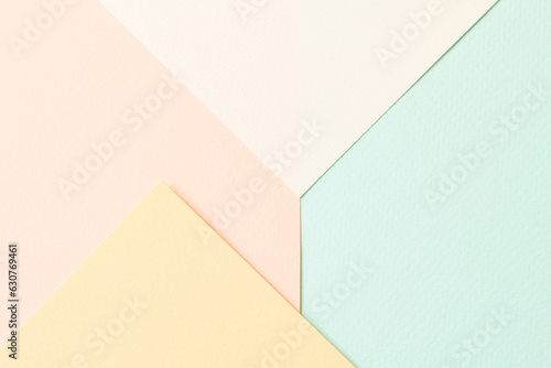 Rough kraft paper pieces collage background, geometric paper texture pastel colors. Mockup with copy space for text.