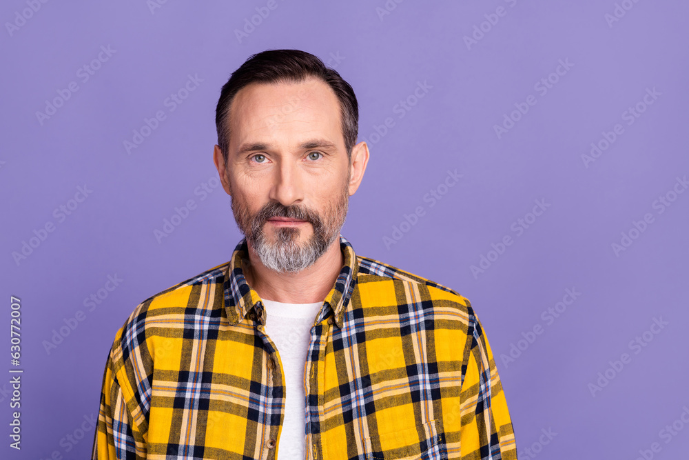 Photo of candid sincere serious man with white gray beard wear yellow plaid shirt look at camera isolated on purple color background