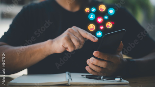 Social media and digital online concept.Social Distancing ,Working From Home concept. man using smart phone with Social media. The concept of living on vacation and playing social media. photo