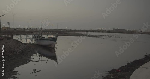 Wooden boat in a harbour at dusk  Jizan  Saudi Arabia photo