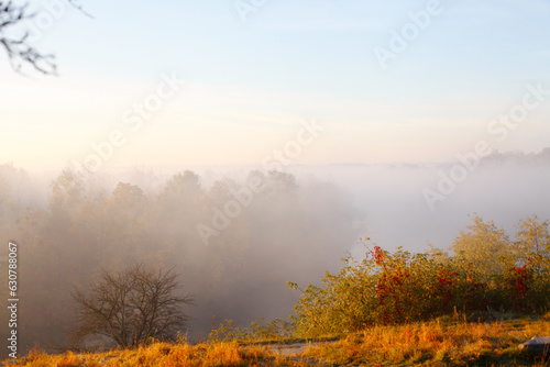 Morning autumn landscape with fog on river