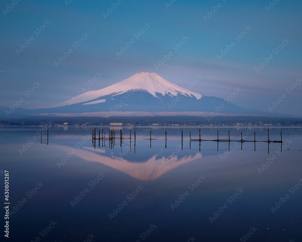Mount Fuji is illuminated by the early morning light reflecting off the waters of Lake Kawaguchi