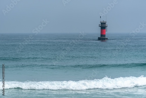 Small lighthouse in the middle of the ocean