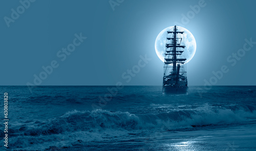 Fototapeta Naklejka Na Ścianę i Meble -  Sailing old ship in calm sea - Night sky with moon in the clouds 