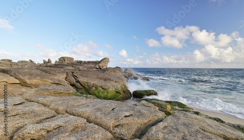Scenic view of ocean waves crashing against the rocky shoreline, Brittany, France