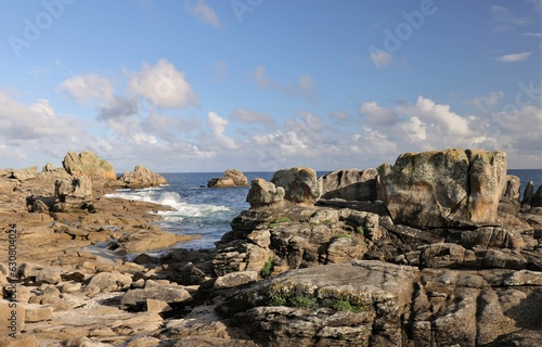 Scenic view of ocean waves crashing against the rocky shoreline, Brittany, France