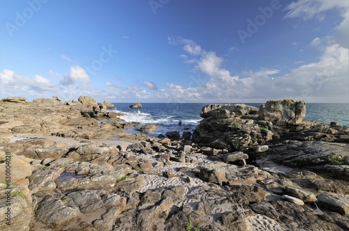 Scenic view of ocean waves crashing against the rocky shoreline, Brittany, France © Buellom/Wirestock Creators