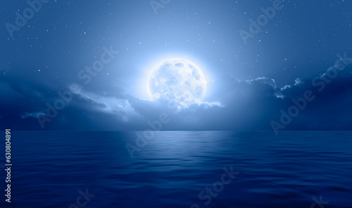 Night sky with moon in the dark clouds and darkblue sea in the foreground  Elements of this image furnished by NASA 
