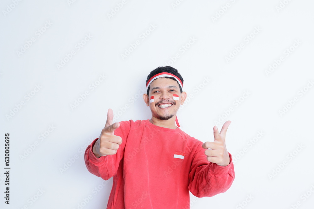 Indonesian man showing excitement with thumbs up when celebrating independence day