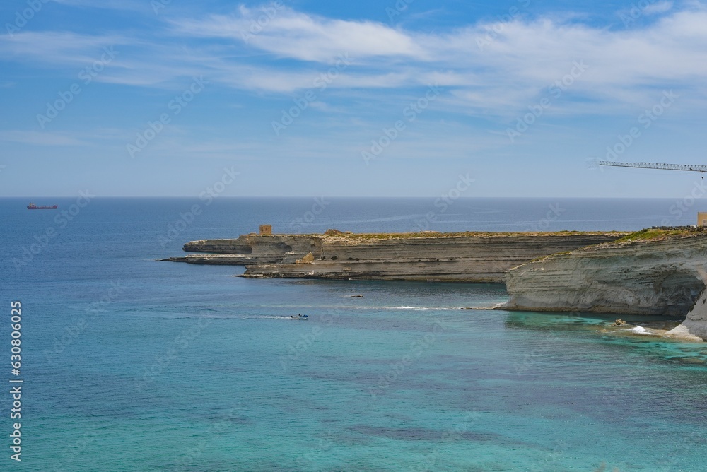 Seascape featuring a vast expanse of tranquil blue sea with a few boats scattered on the surface Seascape featuring a vast expanse of tranquil blue sea with a few boats scattered on the surface
