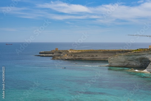 Seascape featuring a vast expanse of tranquil blue sea with a few boats scattered on the surface