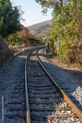 Vertical shot of a winding railway track curves through the landscape
