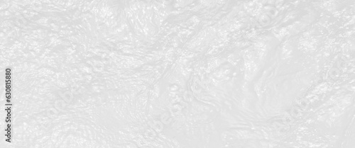 Ripple water texture on white background, shadow of water on sunlight, white water with ripples on the surface, defocus blurred transparent white colored clear calm water surface texture.