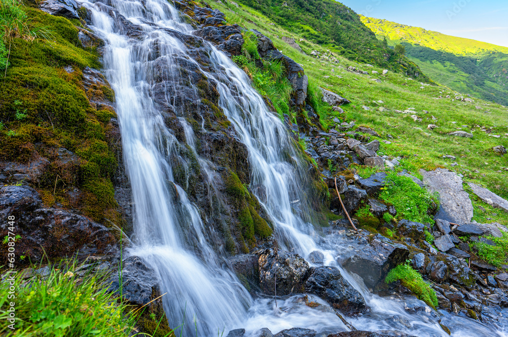 Naklejka premium Waterfall in Fagaras Mountains, Romania.