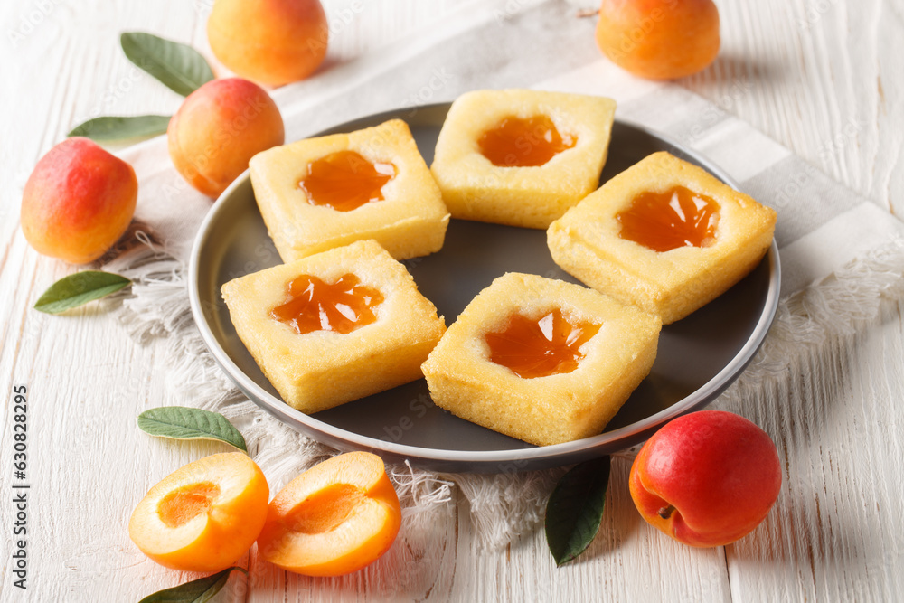 Homemade fresh italian cookies with apricot jam close-up on a plate on the table. Horizontal