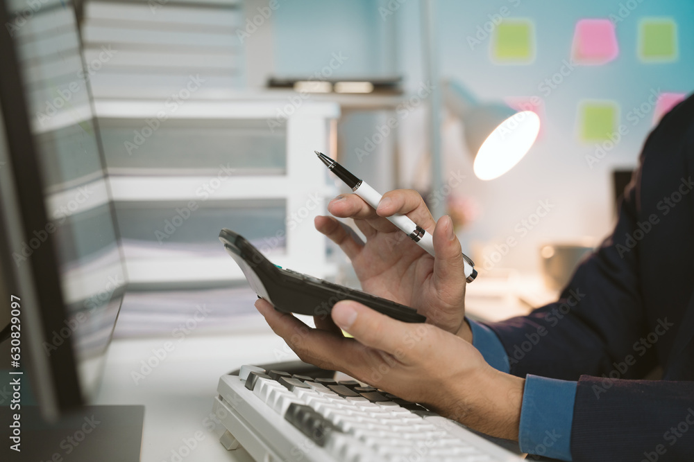 Obraz premium young man working at night Work comfortably on your smartphone. Social media chat at the office