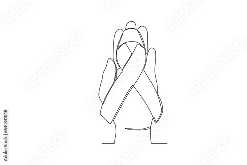 A hand holds the baby's birth ribbon. Pregnancy and infant loss awareness month