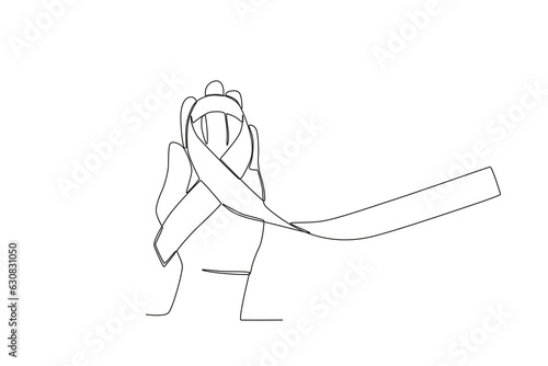 A hand holding a ribbon. Pregnancy and infant loss awareness month