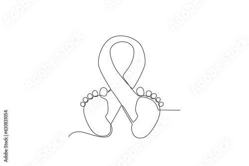 A ribbon and a pair of baby legs. Pregnancy and infant loss awareness month
