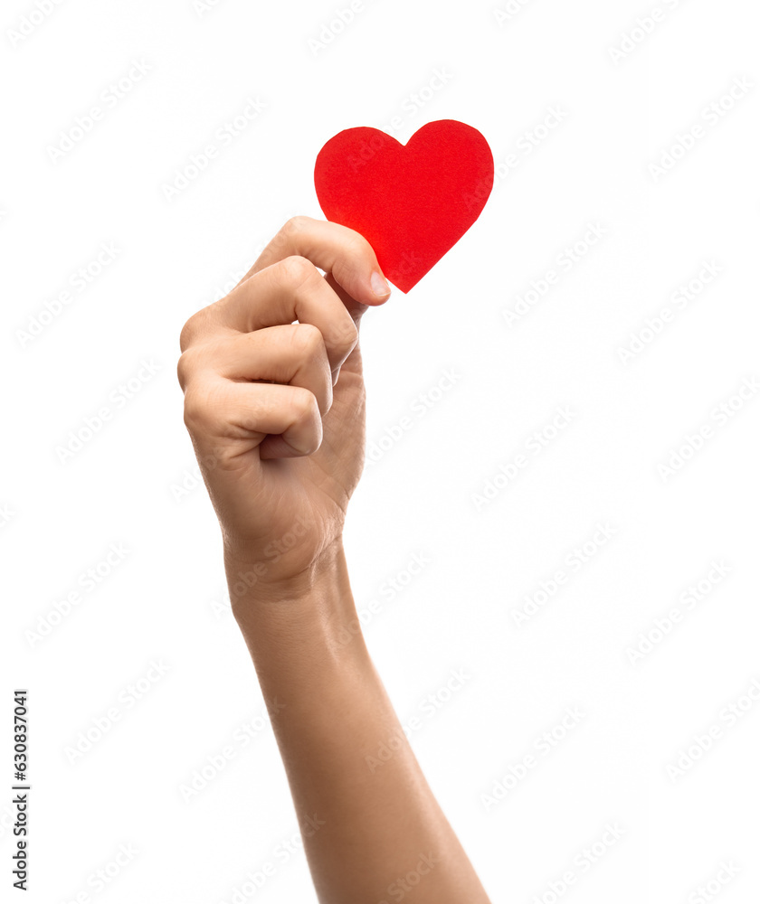 Obraz premium charity, love and health concept - close up of hand holding red paper heart over white background