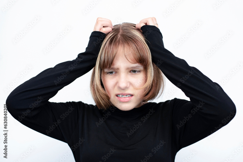 A teenage girl with metal braces and colored rubber bands on her teeth