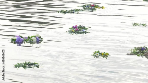 flowers wreath with burning candles float in water. old national traditions, fortune telling for pagan holiday Ivan Kupala. Summer Solstice Day, Midsummer, wiccan Litha sabbat rituals 