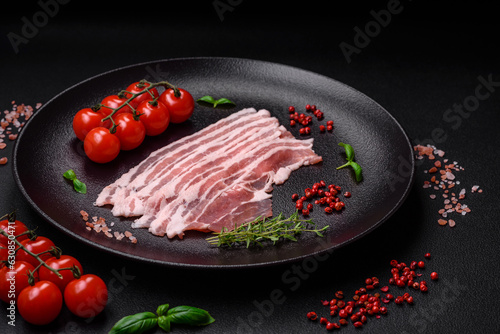 Fresh raw bacon cut into slices with salt, spices and herbs