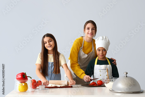 Female chef with little chi...