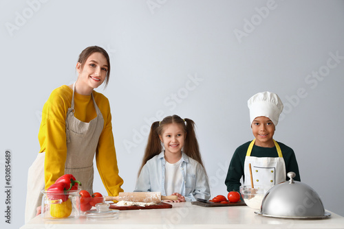 Female chef with little chi...