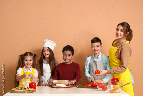 Female chef with group of l...