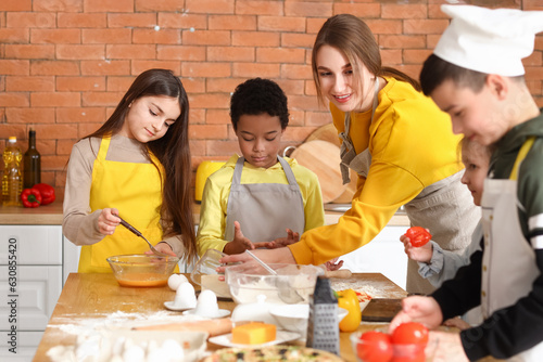 Female chef with group of l...