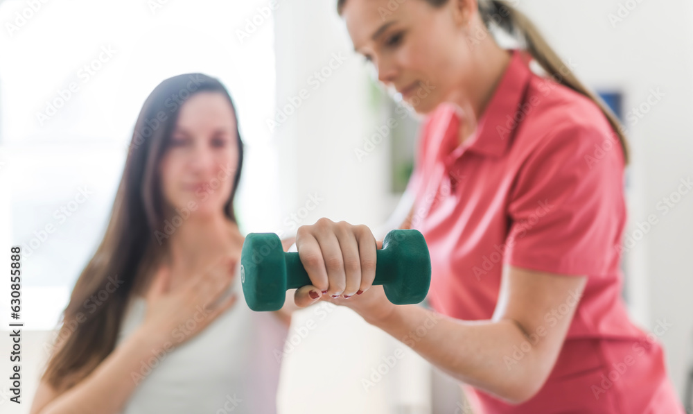 Modern rehabilitation physiotherapy clinic with professional and client Modern rehabilitation physiotherapy clinic with professional and client