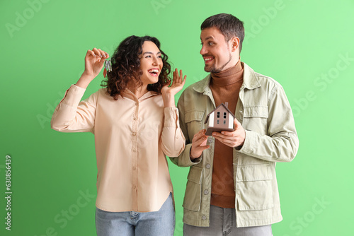 Happy young couple with hou...