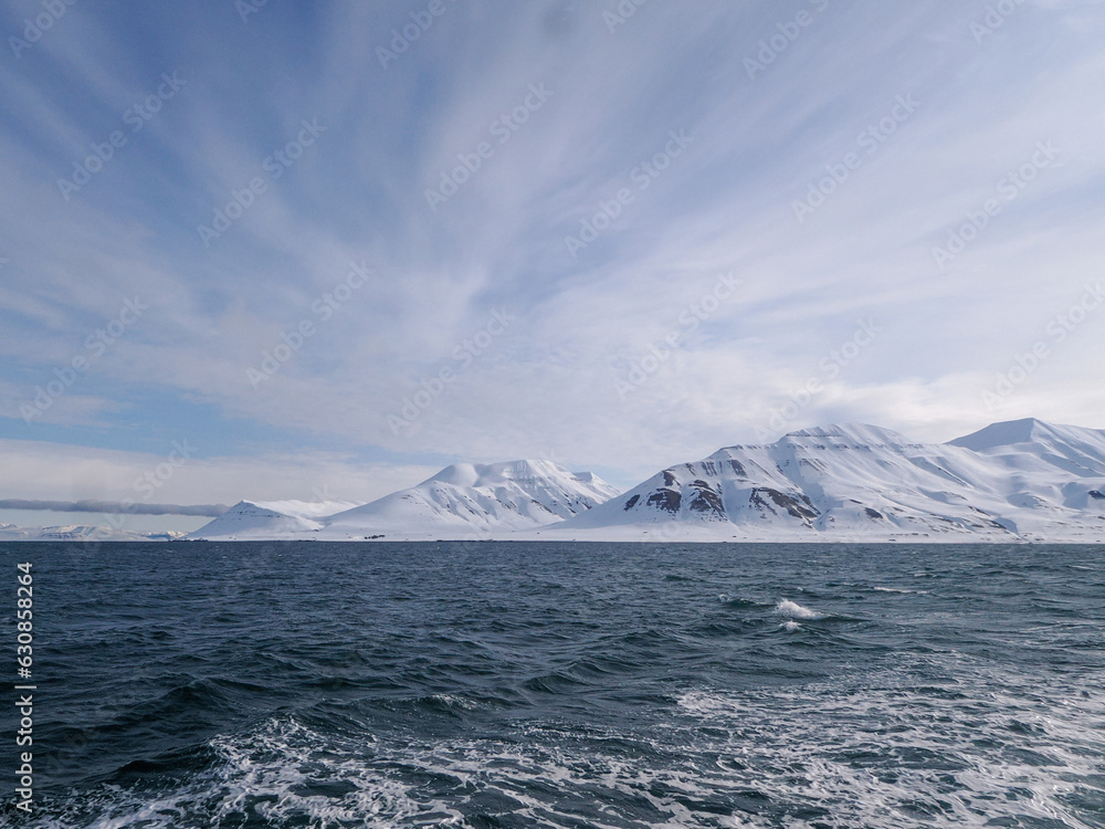 Landscape of Arctic Ocean with shore, hills, snow and sea, Spitsbergen