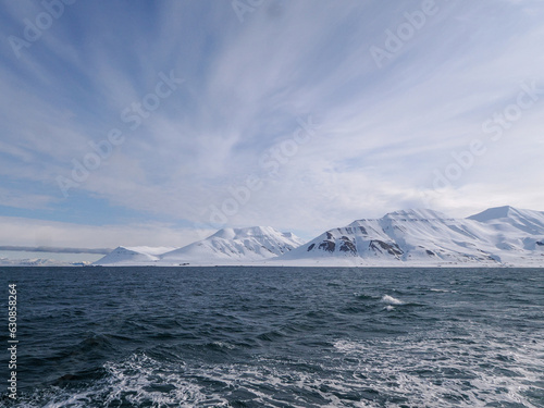 Landscape of Arctic Ocean with shore, hills, snow and sea, Spitsbergen