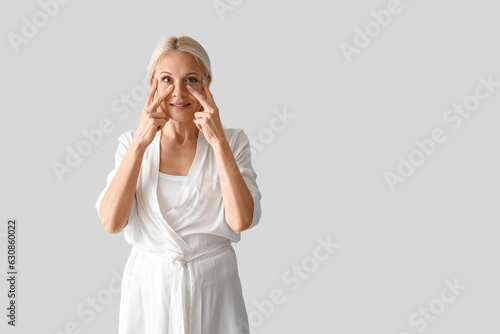 Mature woman doing face bui...