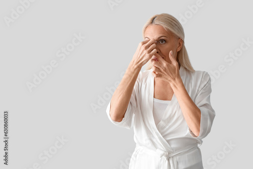 Mature woman doing face bui...