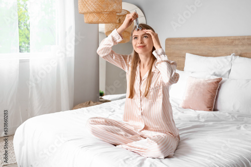 Young woman with facial mas...