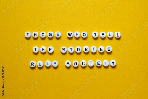 Those who tell the stories rule society - word concept on building blocks, text photo