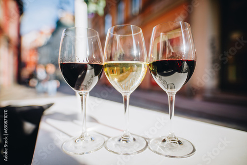 Three glasses of wine on a restaurant table outdoors