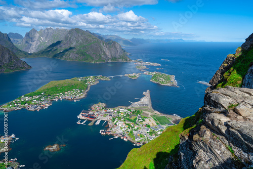 Amazing view from Reinebringen view point. Mountains and blue sea at Lofoten islands. Scenery of Reine fishing village. One of most popular hiking trails in North of Norway. © Ilja
