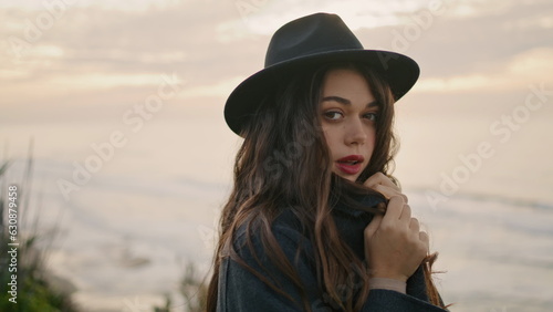 Dreamy woman posing coast cloudy day closeup. Portrait attractive brunette girl. © stockbusters