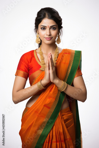 Indian pretty woman in saree in prayer pose or welcoming guests, isolated over white background