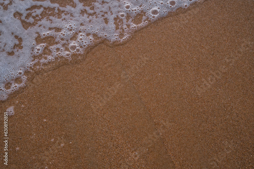 Waves on the beach of Trafalgar, Cádiz. Sand. Background.