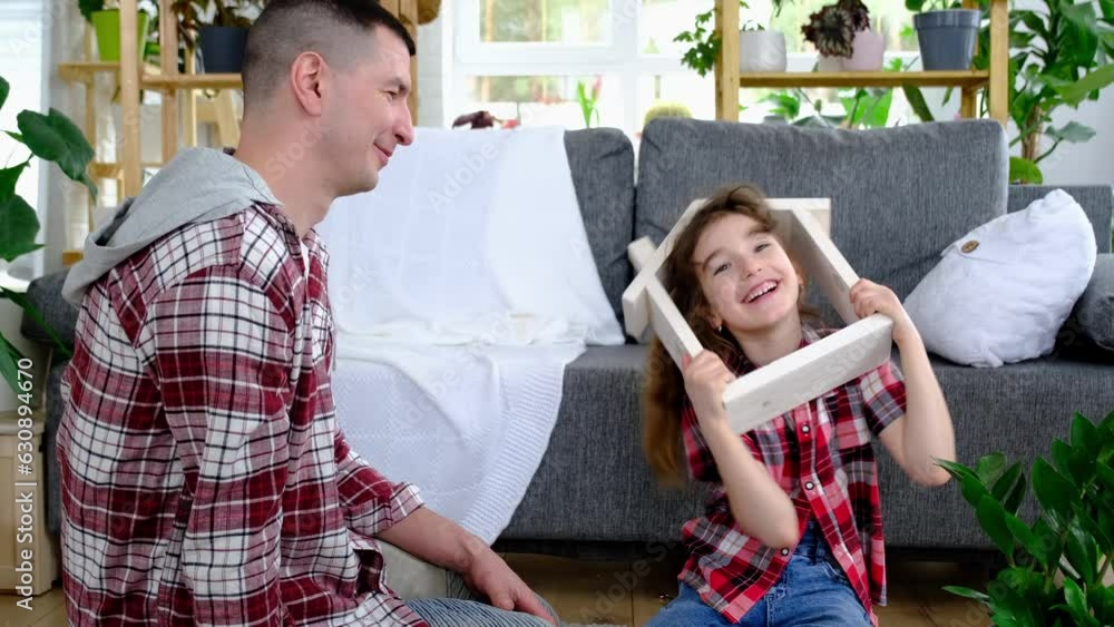 Incomplete family dad and daughter are enjoying new home, sitting on sofa. Mortgage, insurance and protection, buying and moving into your own home, green house with potted plant Incomplete family dad and daughter are enjoying new home, sitting on sofa. Mortgage, insurance and protection, buying and moving into your own home, green house with potted plant