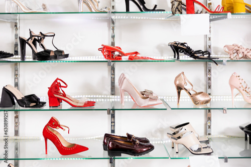 Glass showcase showing different models of women's shoes in shoe store