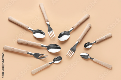 Silver cutlery on beige background