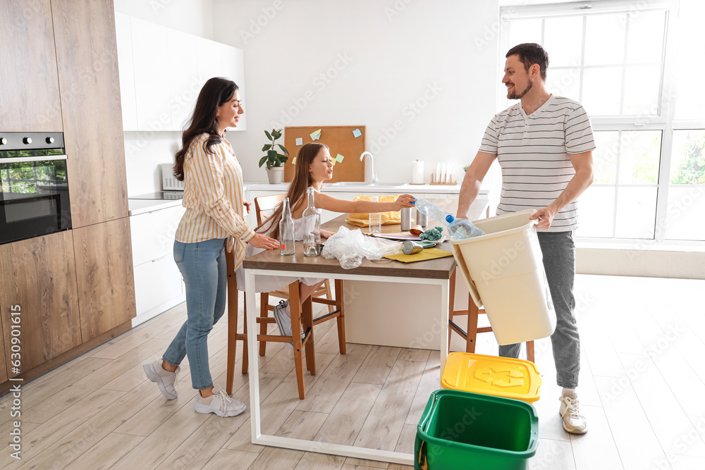 Family sorting plastic garbage in kitchen Family sorting plastic garbage in kitchen